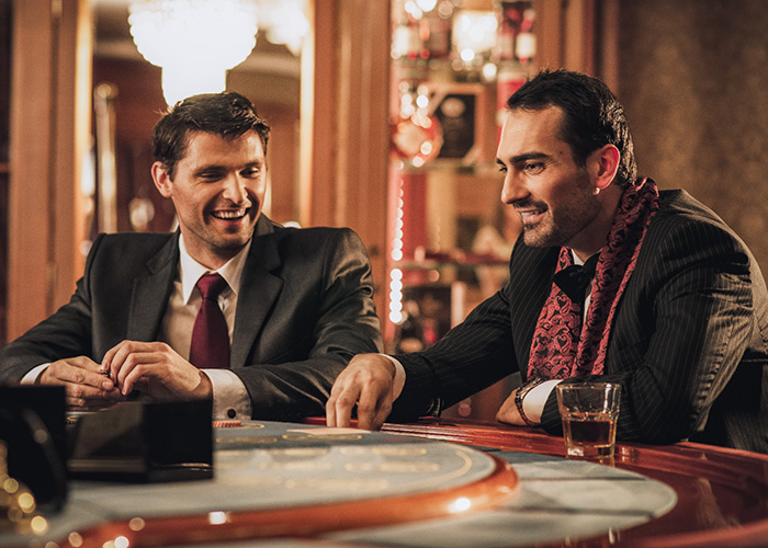 Businessmen networking at a gambling table in casino